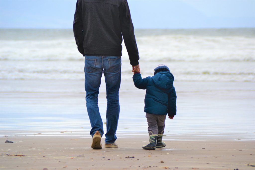 Father and son holding hands